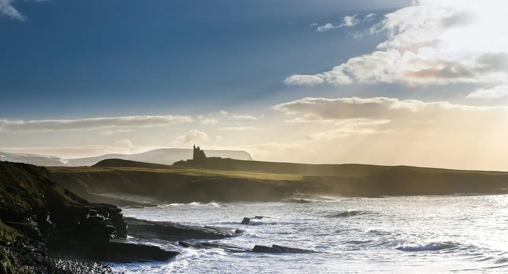 The ruins on the coast of Arranmore Island in Donegal. Silhouetted against sunset skies, legend says selkie royalty once held court at the site of this ancient castle.