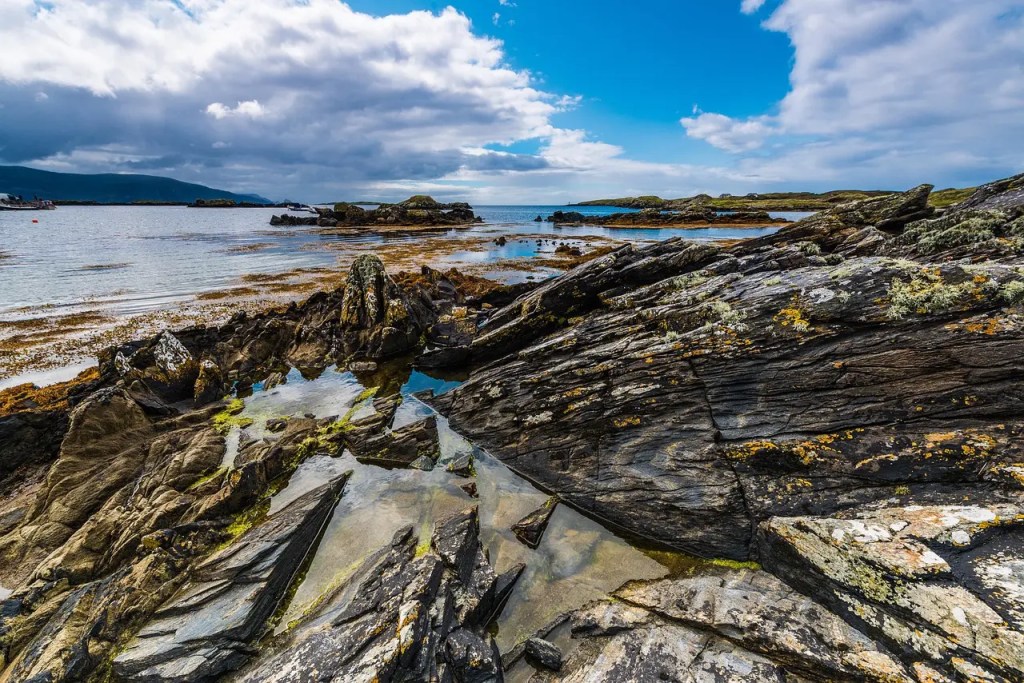 Ancient rock formations at Malin Head, Ireland's northernmost selkie sanctuary, where mystical waters meet rugged coastline in County Donegal.