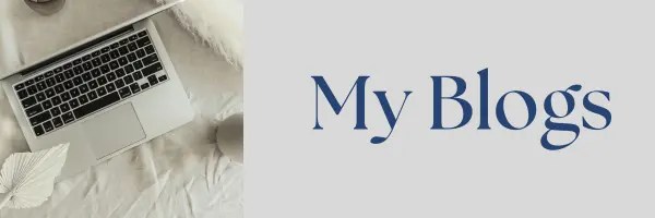 Laptop computer on white bedding with elegant blue serif text that reads My Blogs.